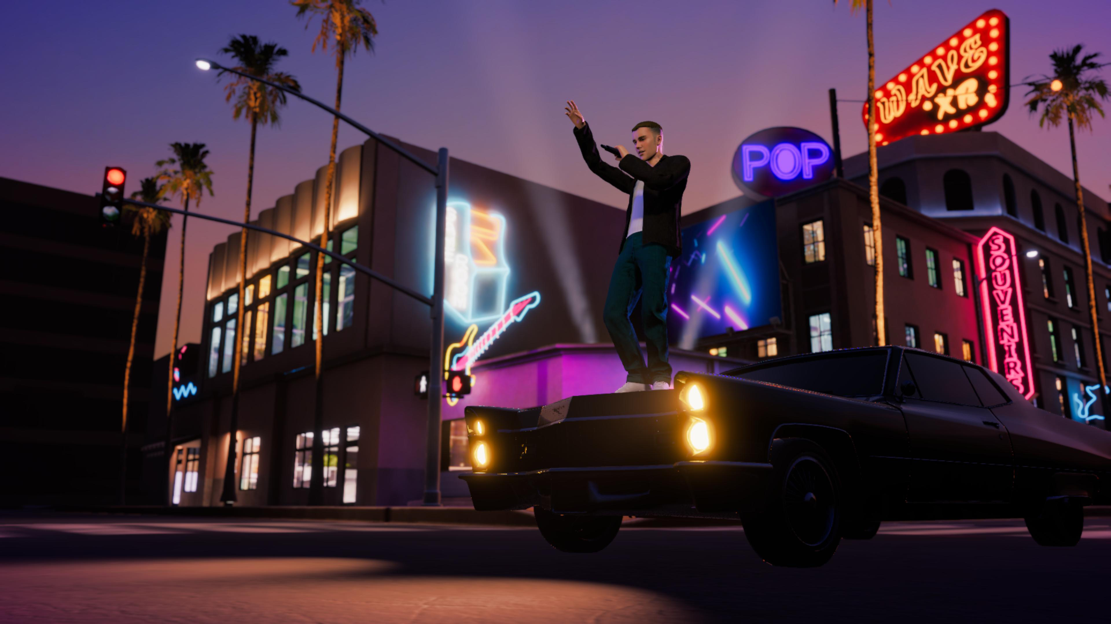 Justin Bieber standing on car in neon-lit city street at night
