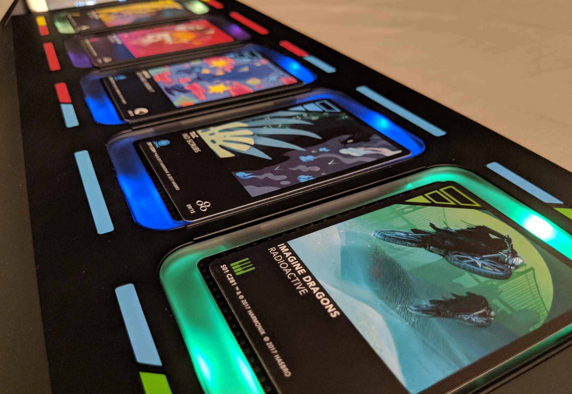 Illuminated DropMix board showing colorful LED lighting with cards in place