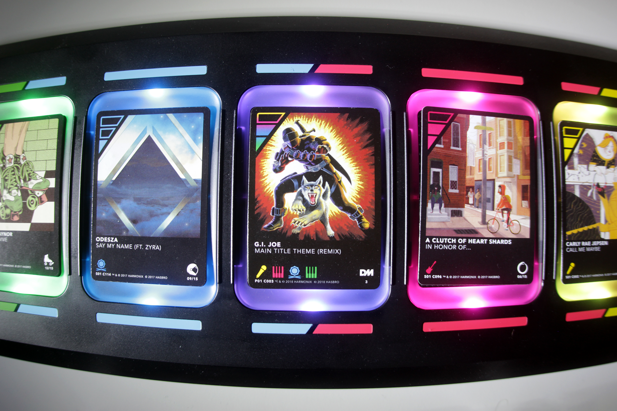 Close-up of artistic DropMix cards on board showing colorful skull designs