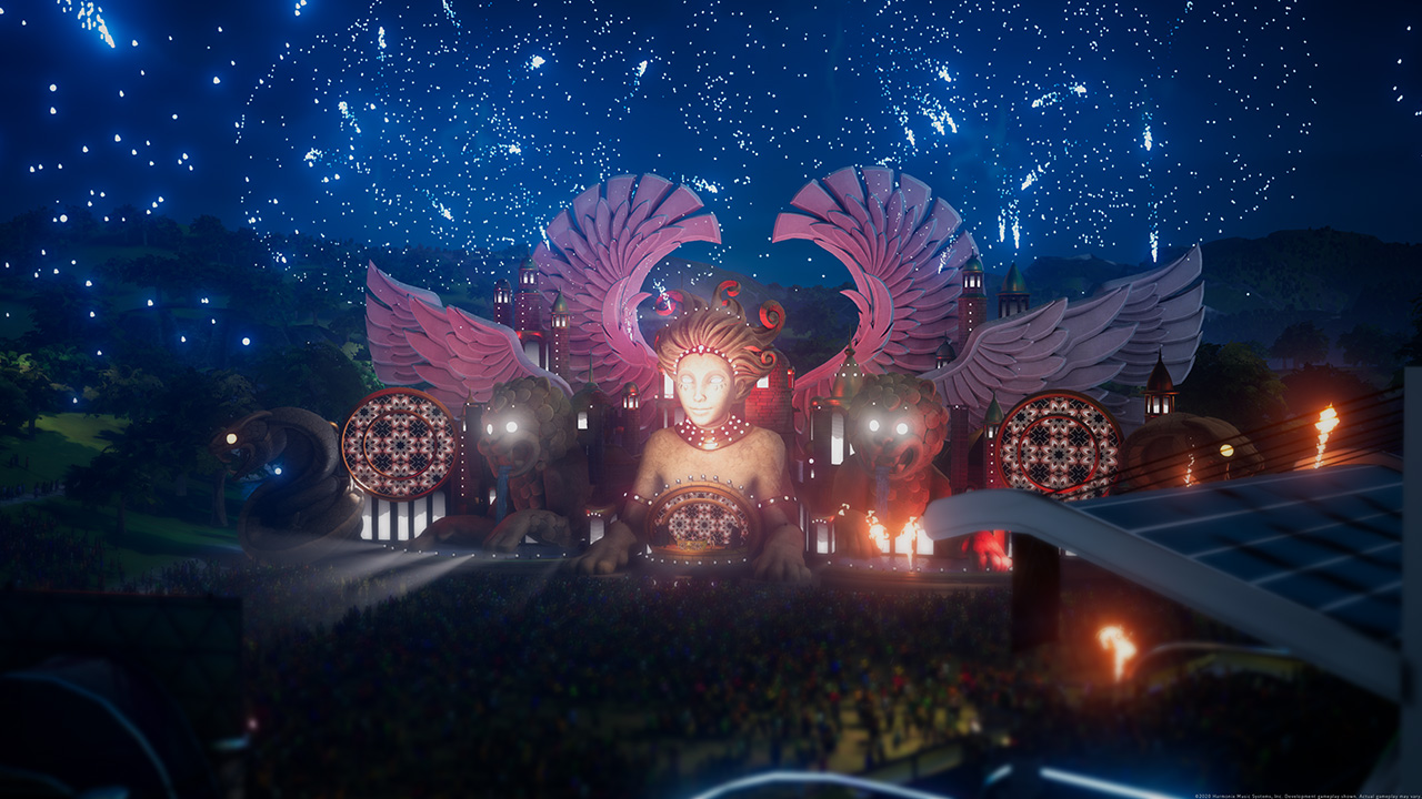 Nighttime festival stage with pink wing structures and fire effects