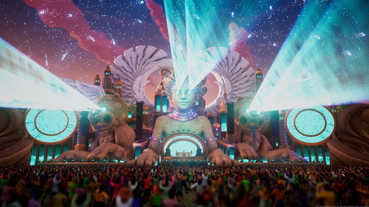 Massive sphinx-inspired stage with cyan and pink wings and huge festival crowd