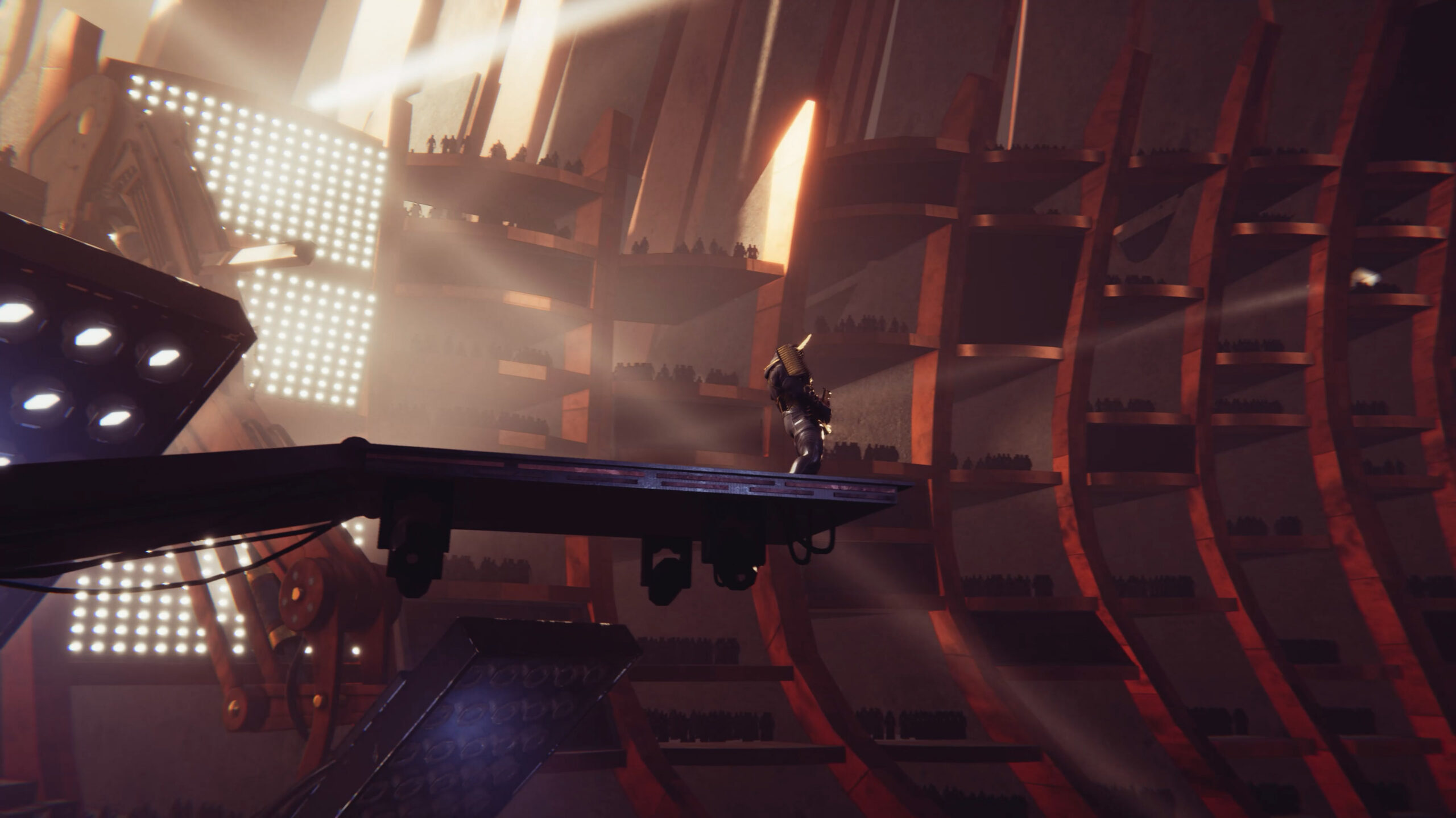 Single performer on elevated platform with dramatic orange lighting and towering geometric structures